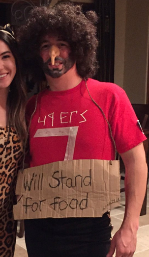 Photo of a white student in costume as Colin Kaepernick, wearing a bushy wig, fake nose and 49ers T-shirt.