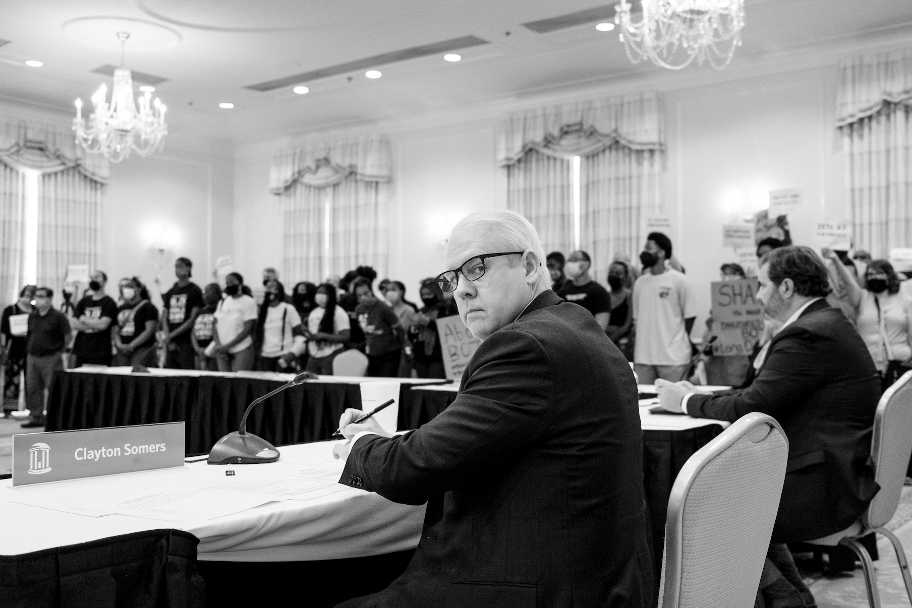 Clayton Somers with protesters in background, by Cornell Watson