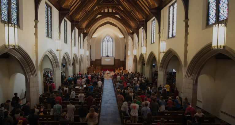 The interior of a chapel at Grove City College, a large room with vaulted ceilings.