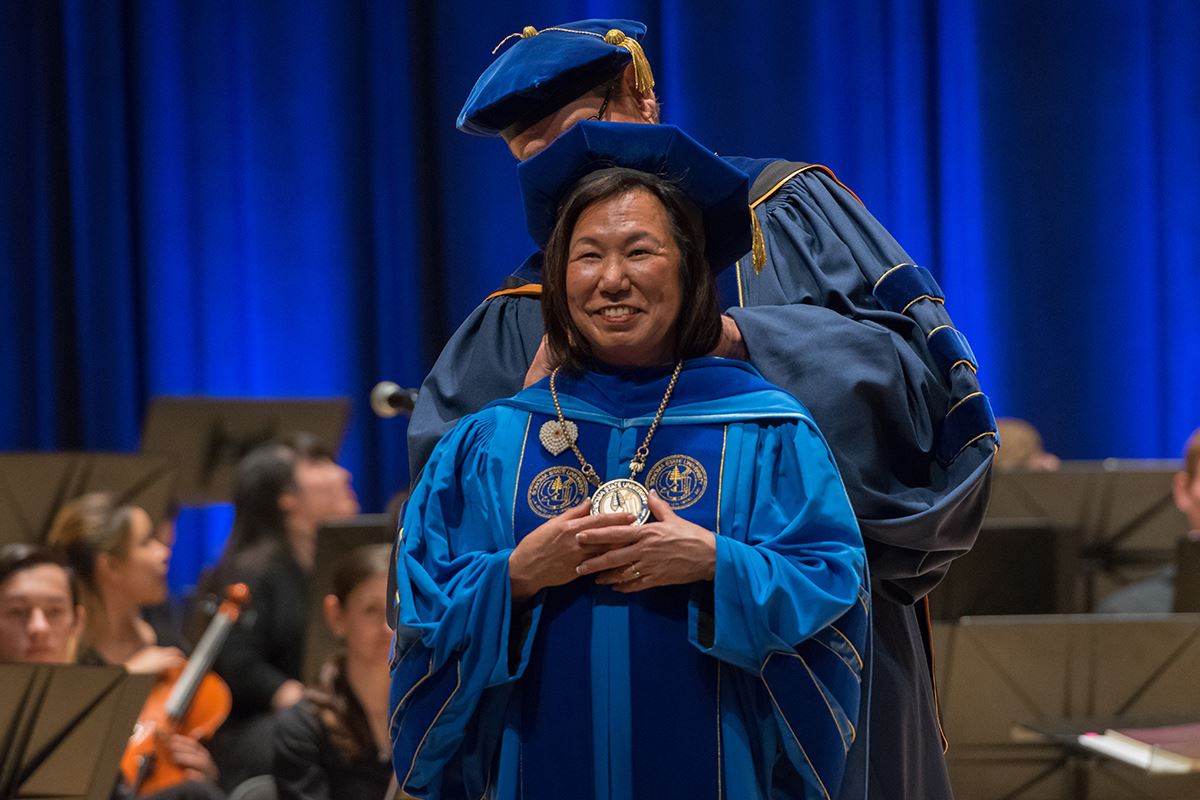 Sonoma State president Judy Sakaki, a Japanese American woman wearing blue academic robes.