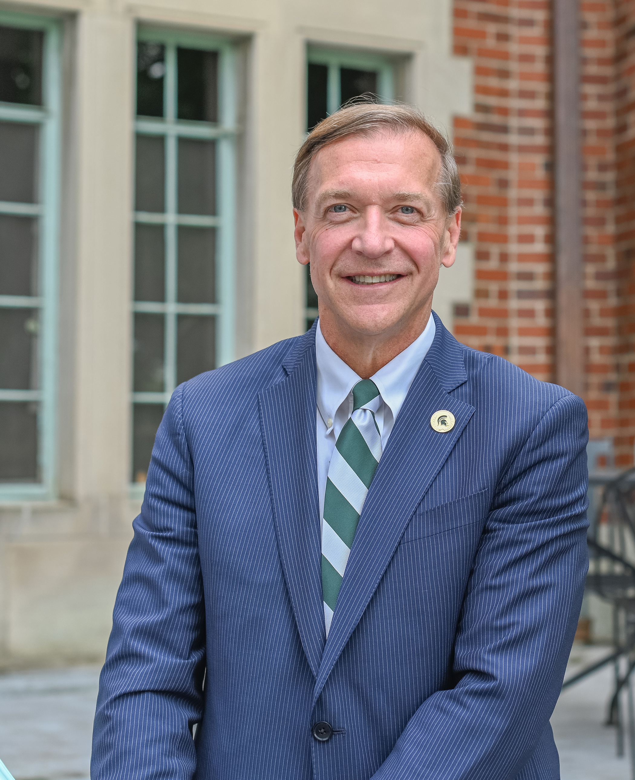 President Samuel Stanley, a white man with sandy hair wearing a business suit.