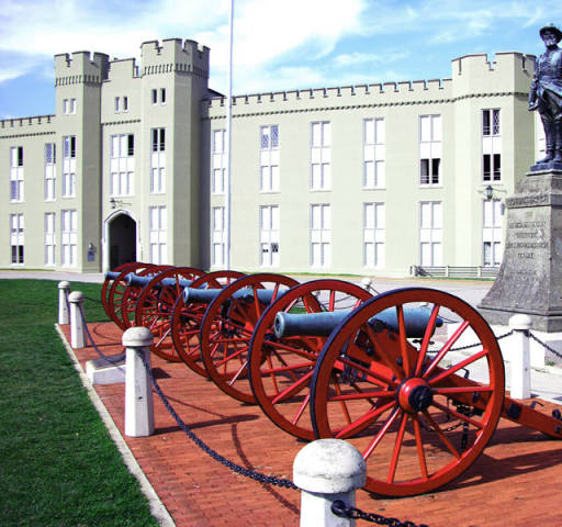 Picture of Stonewall Jackson statue at Virginia Military Institute, behind a line of red cannons.