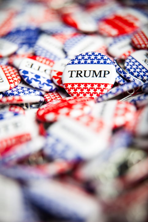 Red, white and blue buttons, some saying "Vote," some saying "Trump."