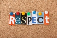 The word “respect,” spelled out in multicolored letters, each tacked onto a cork board with colorful pushpins..